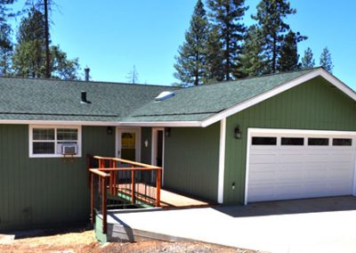 front view of green home with white trim