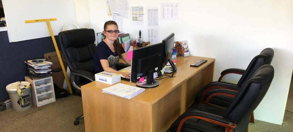 Allison at her desk at Bridges Construction