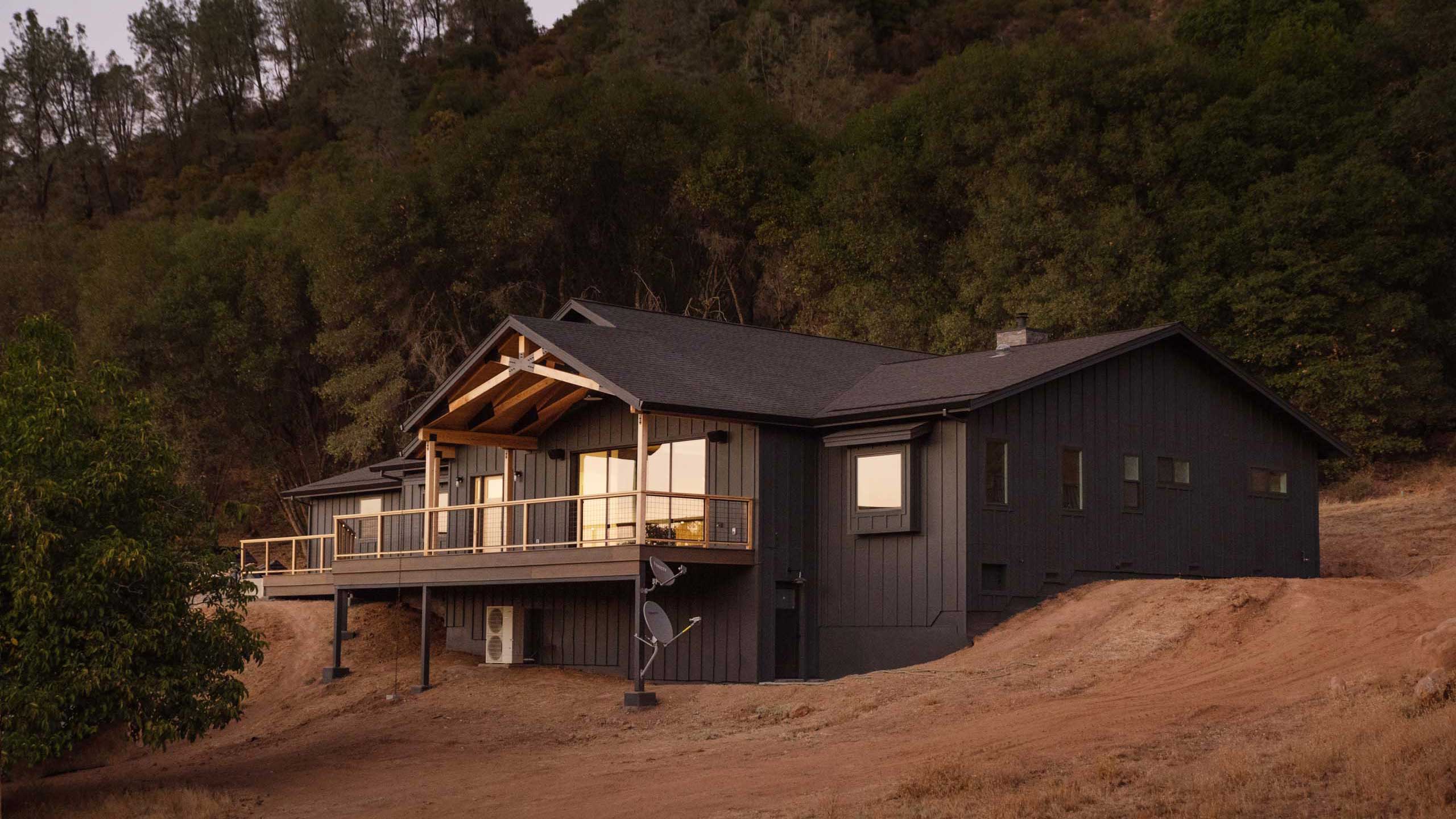 rear view of home with deck at sunset